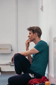 A thoughtful person sitting on the ground